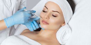The doctor cosmetologist makes Lip augmentation procedure of a beautiful woman in a beauty salon.Cosmetology skin care.