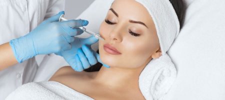 The doctor cosmetologist makes Lip augmentation procedure of a beautiful woman in a beauty salon.Cosmetology skin care.